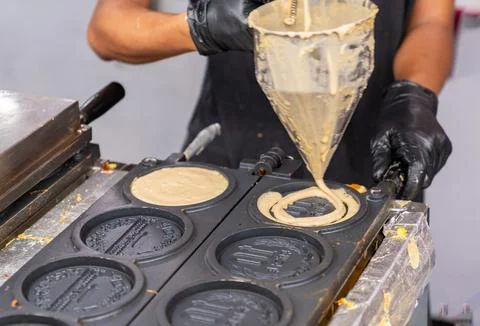 Chef drop Fermented flour on hot pan to make pancake shaped coin. Stock Photos