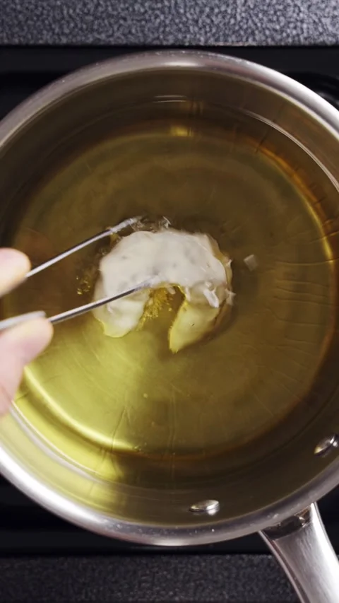 Chef drops battered shrimp into hot oil in restaurant kitchen. Stock Footage 341951435