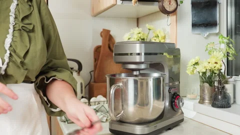 Chef Drops Scissors Beside Working Mixer in Bright Kitchen Scene Stock Footage 307124092