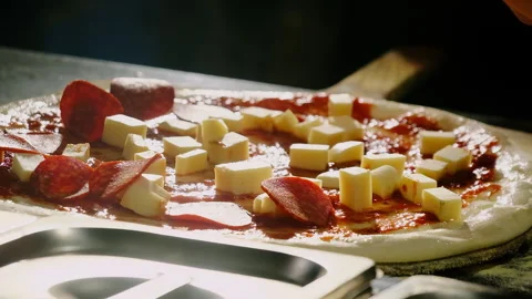 Chef drops slice from fingertips nudging topping into gaps Stock Footage 325071045
