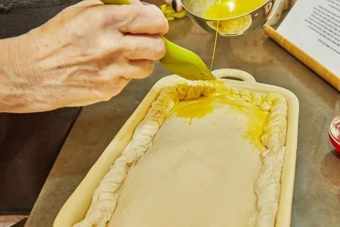 Chef dunks an egg on souffle made from French potatoes, zucchini, cauliflower Stock Photos