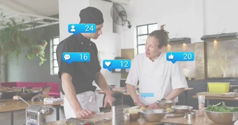 Chef duo starting slicing and explaining technique igniting social icons rising Stock Footage 318776414