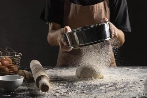 Chef dusting flour dough. High quality photo Stock Photos