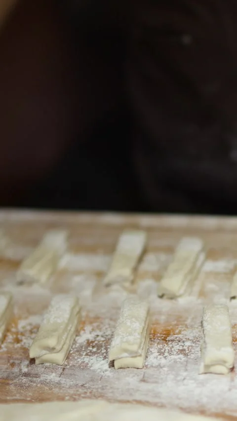 Chef Dusting Flour Over Dough Strips for Asian Street Food Stock Footage 340374536