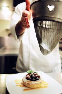 Chef dusting fruit dessert Stock Photos