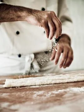 A chef dusting gnocchi dough with flour Stock Photos