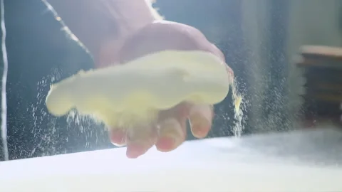 Chef dusts dough with flour setting portion on worktop Stock Footage 325069233