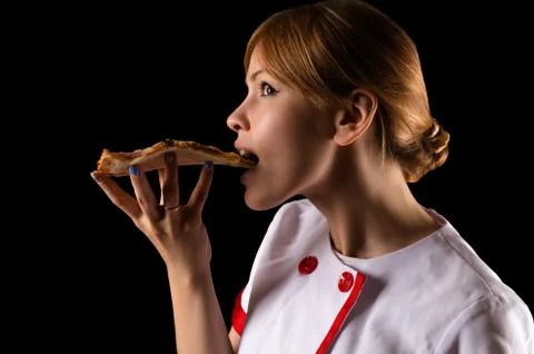 Chef eating a slice of pizza Stock Photos