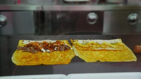 Chef expertly constructs delicious meat wrap on stainless surface Video stock 331940334