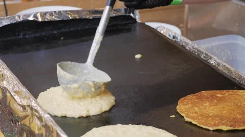 Chef expertly cooks and prepares flavorful stuffed crepe on a sizzling hot Stock Footage 278917726