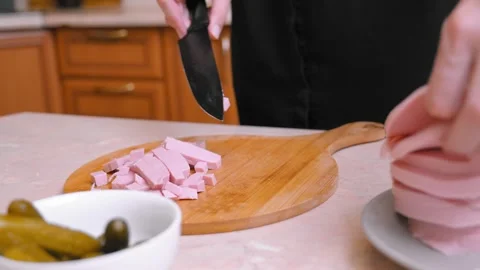 Chef Expertly Cuts Ham Into Uniform Pieces Using Precise Knife Techniques Video stock 331149287