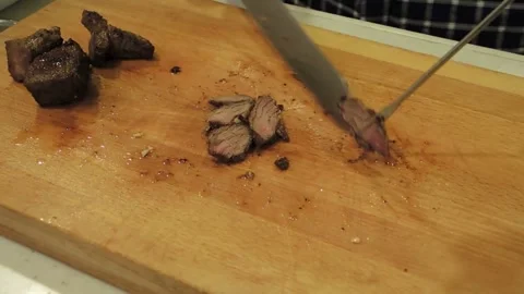 Chef expertly slicing a steak to create a tender, melt in your mouth cut. 4k Stock Footage 336581627