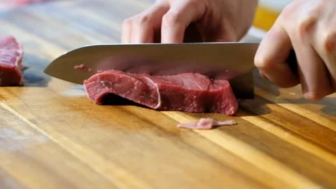 Chef expertly slicing a steak to create a tender, melt in your mouth cut. 4k Stock Footage 336581655