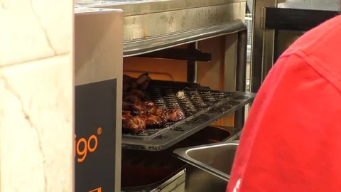 Chef Extracts Delicious Meat Chops from the combi steamer Video stock 129578915