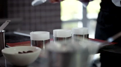Chef filling chocolate into cases. Stock Footage 64117498