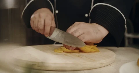 Chef finely chopped large yellow sweet bell pepper with sharp knife. 4K Slow Stock Footage 113513309