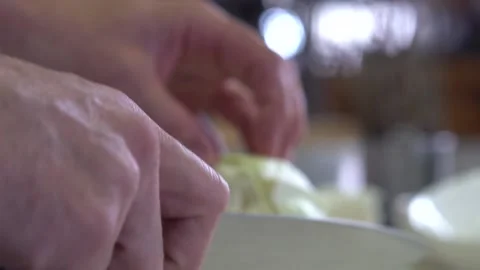 Chef finely chopping cabbage on chopping board, close up Stock Footage
