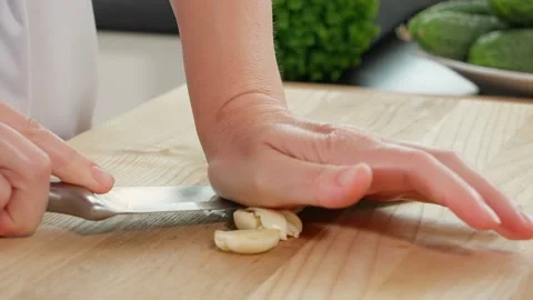 Chef finely chops garlic with a sharp knife, crush garlic with a knife Stock Footage 270146244