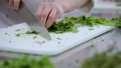A chef finely chops parsley Stock Footage 90971059
