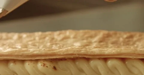 Chef finish the secod level of puff pastry cake Stock Footage 76280792