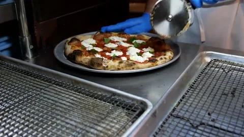 The chef finished the pizza. Cut the pizza into equal parts Stock Footage 171736784