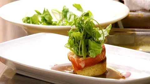 Chef finishes off main course dish by topping with chicken Stock Footage 117249287