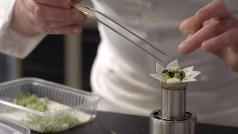 Chef finishing a garnish Stockbeeldmateriaal 92070629