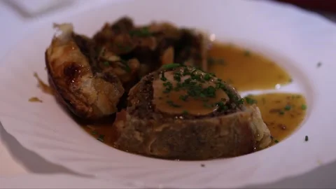 Chef finishing preparing beef wellington dish Stock Footage 324150995