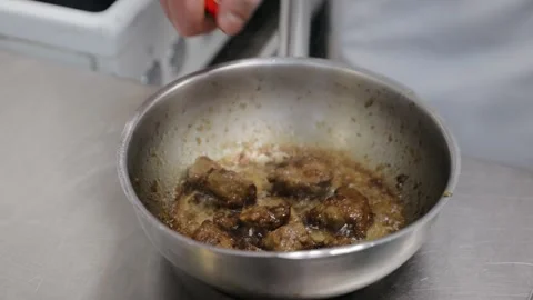 Chef fires up the flambe on a hot pan at the kitchen in slow motion, big open Stock Footage 134208569