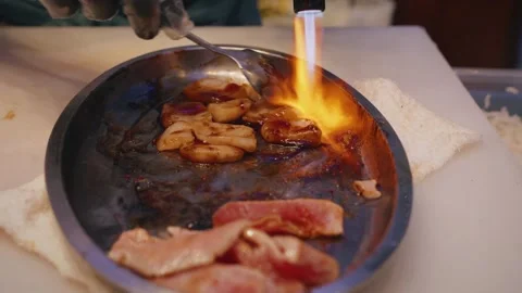 Chef flambeing squid with eel sauce – 4K video Stock Footage 315565012