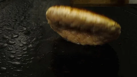 Chef flip over meat burger on the frying surface, street food Stock Footage 76897803