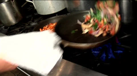 Chef flipping pan with pasta and vegetables 01 Stock Footage 24632274