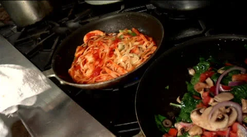Chef flipping pan with pasta and vegetables 02 Stock Footage 24632278