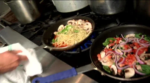 Chef flipping pan with pasta and vegetables 03 Stock Footage 24632295