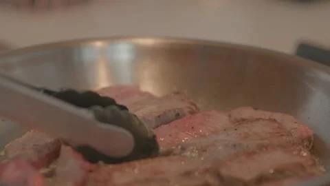 Chef Flips Beef Strips in a Pan Stock Footage 149631270
