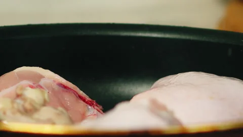 Chef flips chicken thighs on pan Video stock 165793285