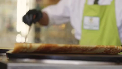 A Chef flips a crepe in a restaurant in Paris Stock Footage 321897398