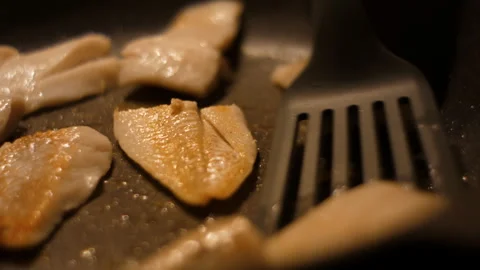 Chef Flips Food Fish. Close up Frying Fillet Hake Fish of Frying Pan With O.. Stock Footage 305926967