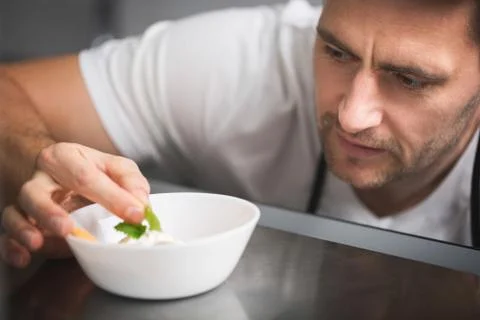 Chef focused on preparing dish Stock Photos