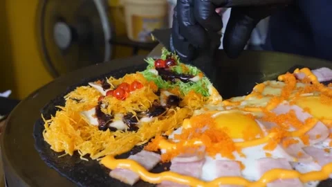 Chef Folding Gourmet Black Charcoal Crepe with Egg and Toppings Stock Footage 345692764