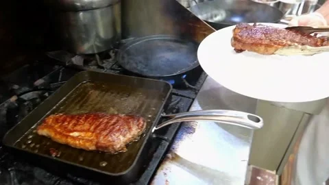 The chef folds the steak in half while it's still hot Stock Footage 171737051