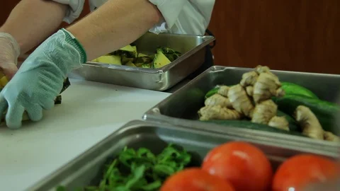 Chef food prep. Moving cut pineapple to container B Stock Footage 101700180