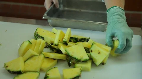 Chef food prep. Moving cut pineapple to container A Video stock 102184939