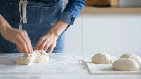 Chef forming the dough on a floured surface and kneading it with his hands Stock Footage 121527418