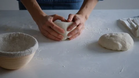 Chef forming the dough on a floured surface and kneading it with his hands. slow Stock Footage 121528529
