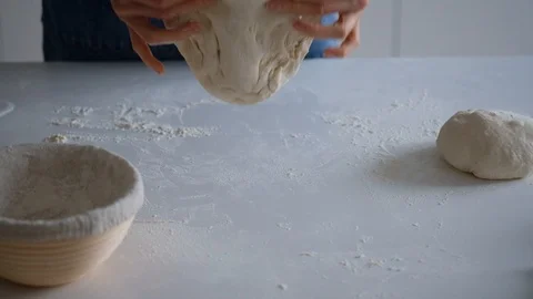 Chef forming the dough on a floured surface and kneading it with his hands. slow Stock Footage 121528588