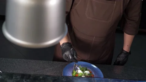 The chef forms a salad for the client, adds the ingredients. HEALTHY EATING Stock Footage 154890059