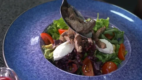 The chef forms a salad for the client, adds the ingredients. HEALTHY EATING Stock Footage 154890642