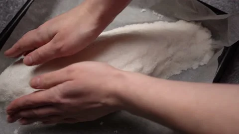 The chef forms a salt cocoon with raw fish inside before baking Stock-Footage 233357442