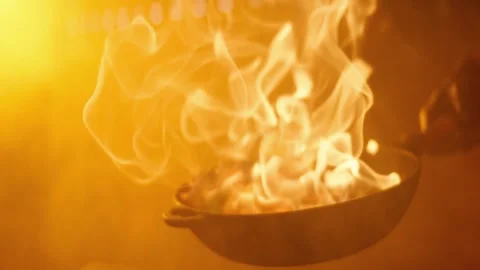 The chef fries in a frying pan enveloped in flames Stock Footage 141154093